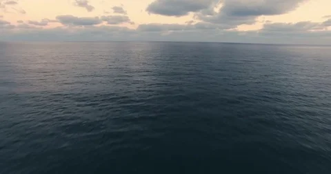 Arial tacking calm sea to the horizon Video stock 82401779