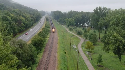 Arial of a train approaching small town usa Stock Footage 114749050