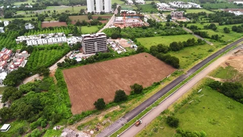 Arial view of Agricultural fields located alongside a road in the Vadodara Stock-Footage 344021502