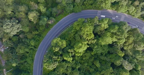 Arial view asphalt road ono mountain green tropical rainforest Stock Footage 282006250