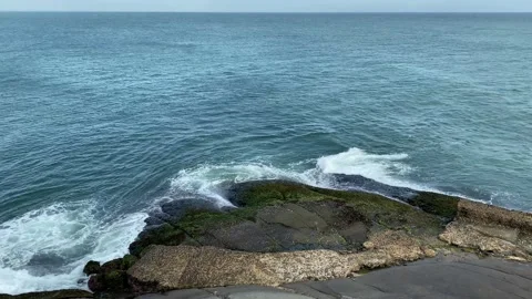 Arial view blue ocean and waves crashing on the rocks Stock-Footage 167695377