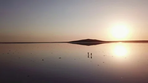 Arial of view from drone when people walk and run around the salt pink lake at Stock Footage 82704869