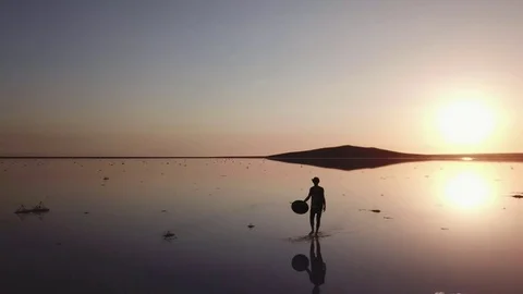 Arial of view from drone when people walk and run around the salt pink lake at Stock Footage 82705001