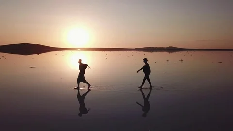 Arial of view from drone when people walk and run around the salt pink lake at Stock Footage 82705347