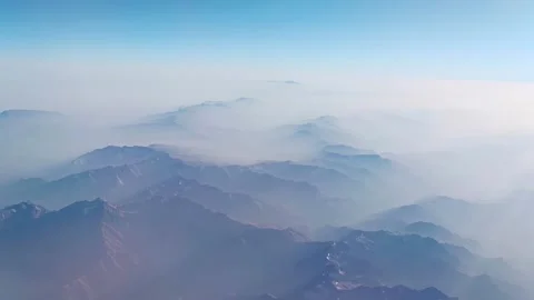The arial view from the plane on the mountain ridge and blue sky Stock Footage 223162352