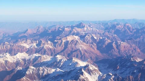 The arial view from the plane on the mountain ridge, clouds and the blue sky Stock Footage 265247129