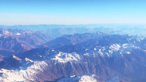 The arial view from the plane on the mountain ridge, clouds and the blue sky Stock Footage 268846396