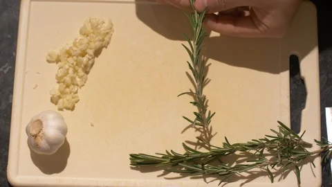 Arial View of Pulling Fresh Rosemary From a Stem Stock Footage 85908462