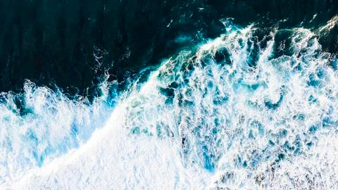 Arial view of splashing oceanic waves with bubbles and foam Stock Photos
