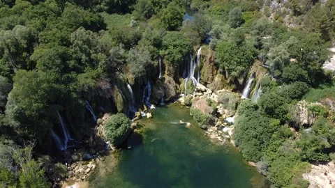 Arial view of waterfall Kravice beautifully sunlit on a summer day Stock Footage 140357955