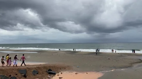 Arial views crowed sandy beach with storm clouds Video stock 167695428