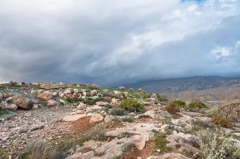 Arid Andalucia landscape under dramatic cloudy sky 写真素材