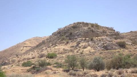 Arid Landscape and Field in Front of Lone Hilltop Stock Footage 78548241