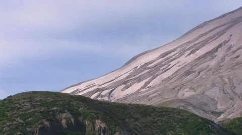An arid mountainside rises above a grassy hillside at Mt. Stock Footage