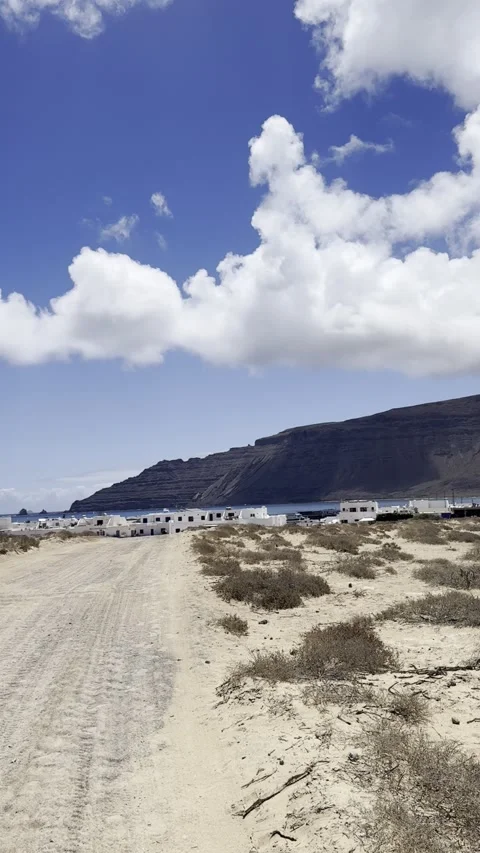 Arid Volcanic Landscape of La Graciosa with Caleta de Sebo and Risco de Famara Stock Footage 320123097