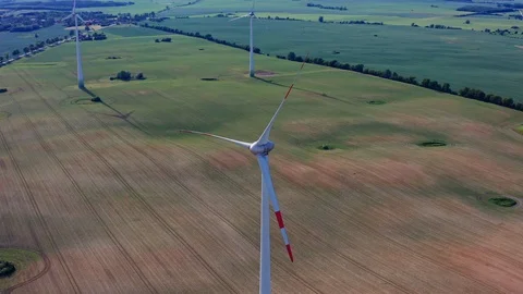 Ariel fly around a windmill and green fields in Germany Stock Footage 116629810