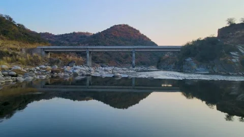 Ariel Shoot Drone move over the River and Bridge in the Valley at Sunset time Stock Footage 168504673