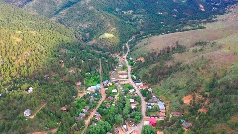 Ariel Shot Above a Tiny Mountain Town Stock Footage 123396345
