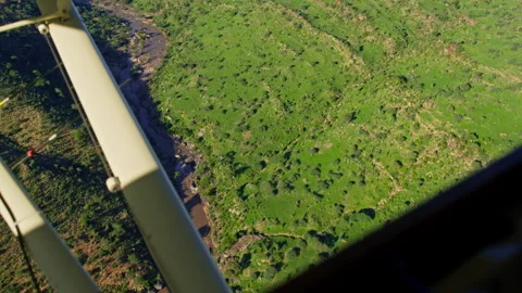 Ariel shot of a river flowing between two valleys during the morning Video stock 256900797