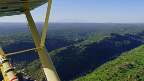 Ariel shot of river flowing between valleys with a mountain background Stock Footage 256900841
