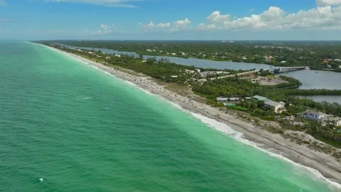 Ariel view of Beach full of people in the middle of an Island Stock Footage 239071627