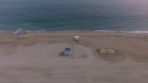 Ariel view of beach with two lifeguard towers at dusk. Stock Footage 94424128
