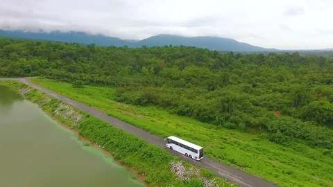 Ariel view the bus on the long way and the beautiful forest view. Stock Footage 128343517