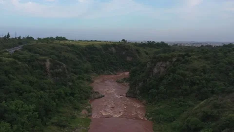 Ariel view of a river surrounded by green hills Stock Footage 133005136