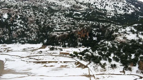 Ariel view of small house covered in snow in the mountains Stock Footage 100261188