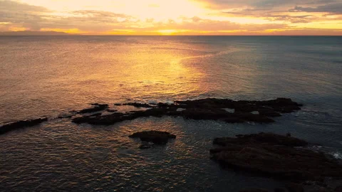 Ariel view of sunset over rocky ocean coast Video stock 149282626