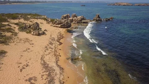 Ariel view of waves onto rocky beach Stock Footage 105042735