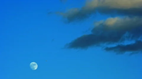 Arising Moon on Blue Sky with Clouds, HD Stock Footage 709835
