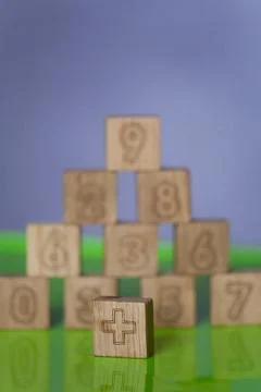 Arithmetic, mathematic, learning concept, numbers background with wooden cube Stock Photos