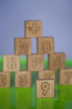 Arithmetic, mathematic, learning concept, numbers background with wooden cube Stock Photos