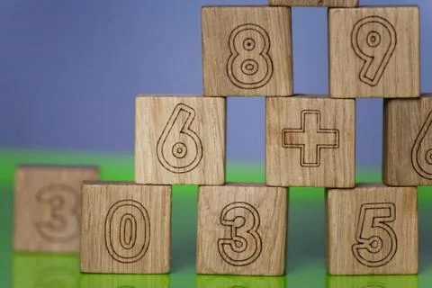 Arithmetic, mathematic, learning concept, numbers background with wooden cube Stock Photos