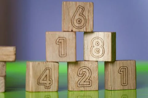 Arithmetic, mathematic, learning concept, numbers background with wooden cube Stock Photos
