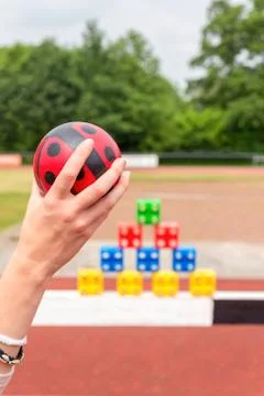 Arm with ball to throw off colored blocks Stock Photos