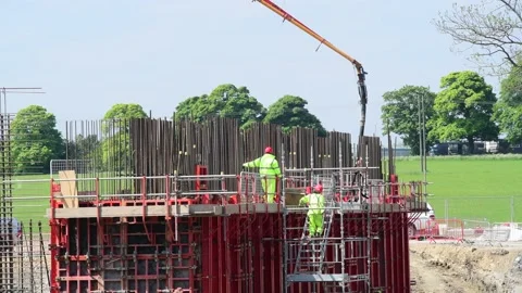 Arm from concrete pump lorry delivering cement to bridge construction  uk Stock Footage 211667347