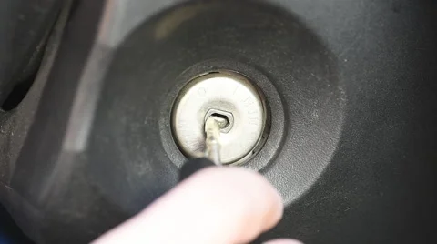 Arm inserts the key into the ignition lock Stock Footage 62079547