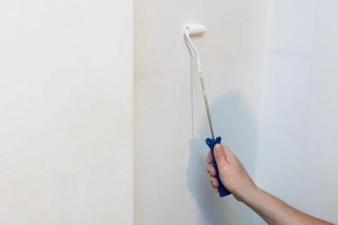 Arm of a painter with roller Stock Photos