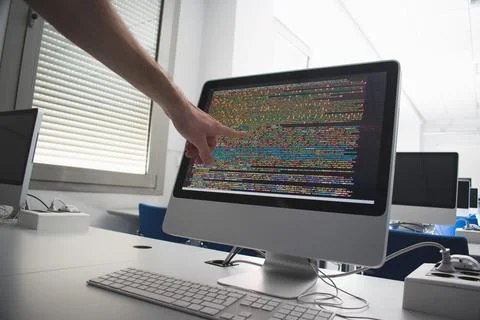 Arm pointing at a computer screen Stock Photos
