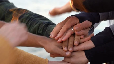 Arm stacked together one by one in unity and teamwork. Many hands connecting Stock Footage 97717657
