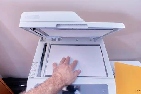Arm of a white or caucasian man making a photocopy on a photocopier in the of Stock Photos