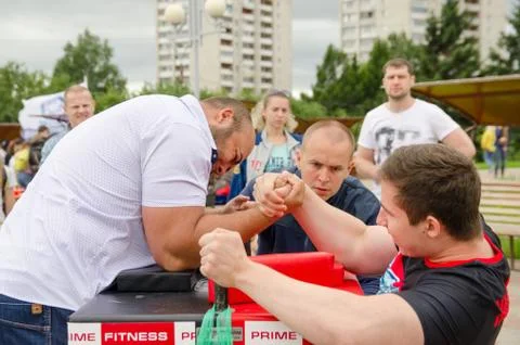 Arm wrestler makes the final breakthrough with the help of power. Arm wrestli Stock Photos
