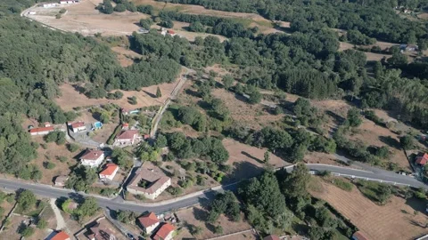 Armariz beside patchwork fields and forest in Ourense, high aerial overview Stock Footage 348720273