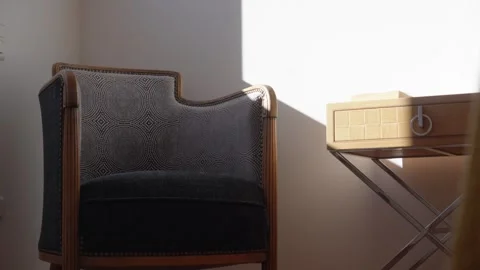 Armchair and Bedside Table in Sunny Minimalist Room Stock Footage 334593506