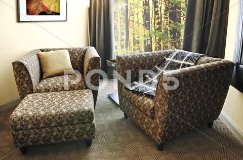 Armchairs with ottoman Stock Photos