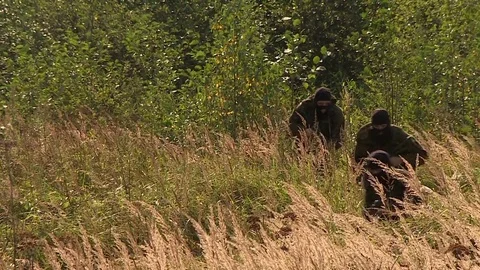 Armed commandos run through the forest with machine guns, a special operation to Stock Footage 80881478