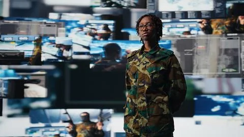 Armed forces operator looking at battlefield communication network feeds Stock Photos
