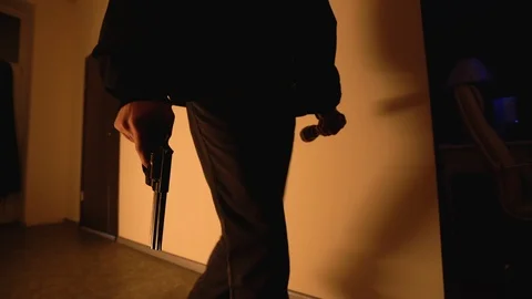Armed man walking carefully in empty hall, policeman chasing criminal with gun Stock Footage 119542732